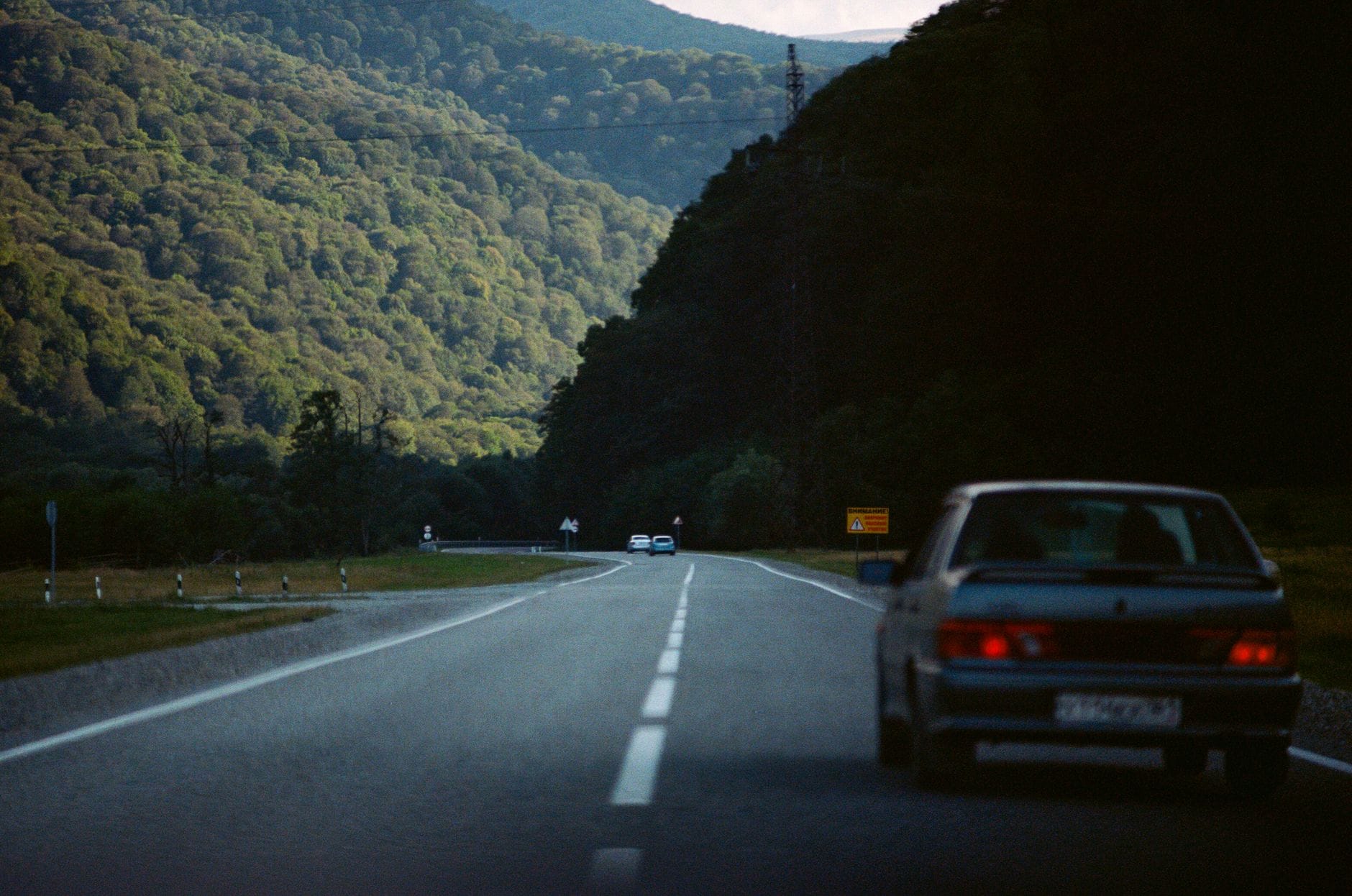 A serene drive through lush mountains in Karachay-Cherkessia, Russia.